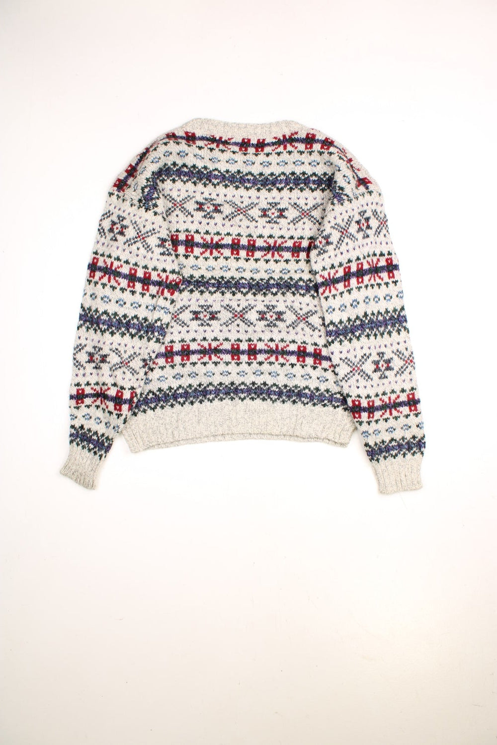 Woolrich patterned jumper in a multicoloured colourway. The knit is a grey/cream with greens reds and purplues throughout. 