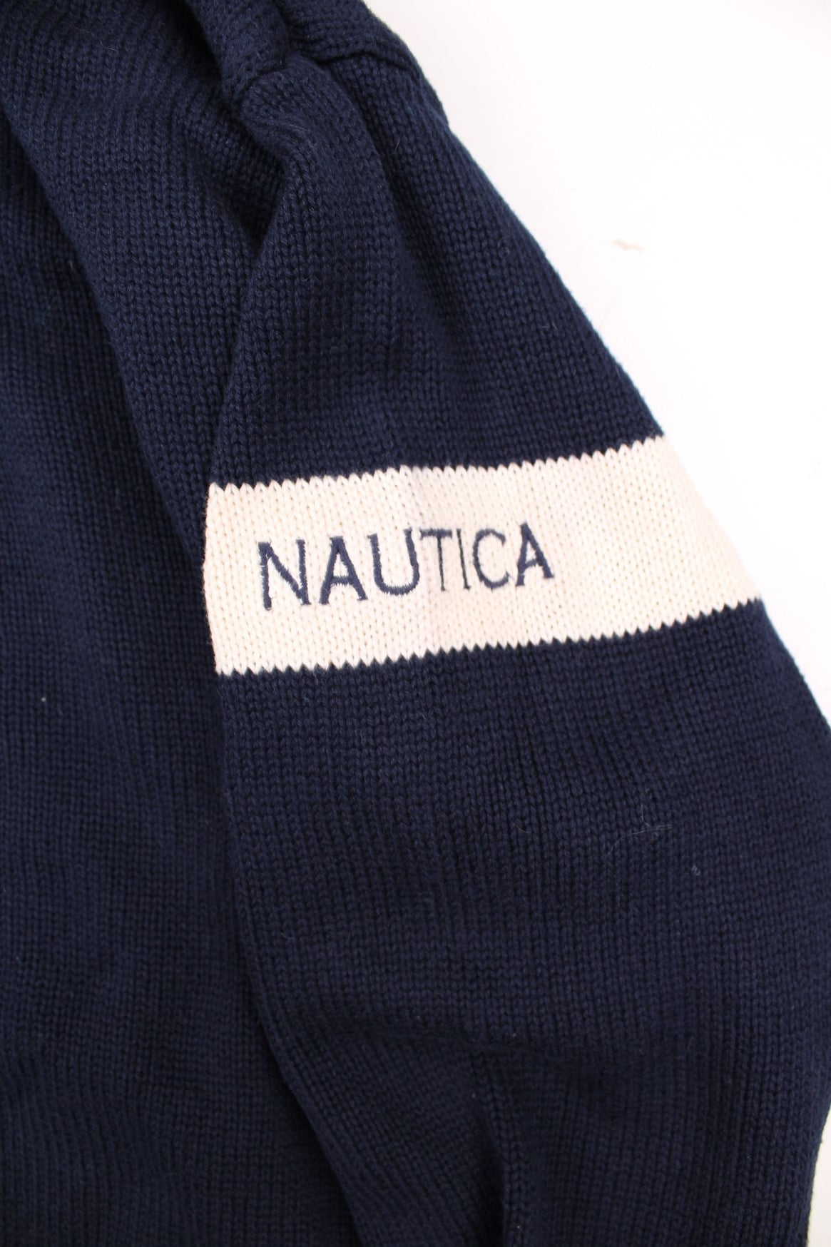 Nautica American Yachting Knitted Jumper in a navy blue and white colourway with the spell out logo and yatch graphic embroidered on the front. 