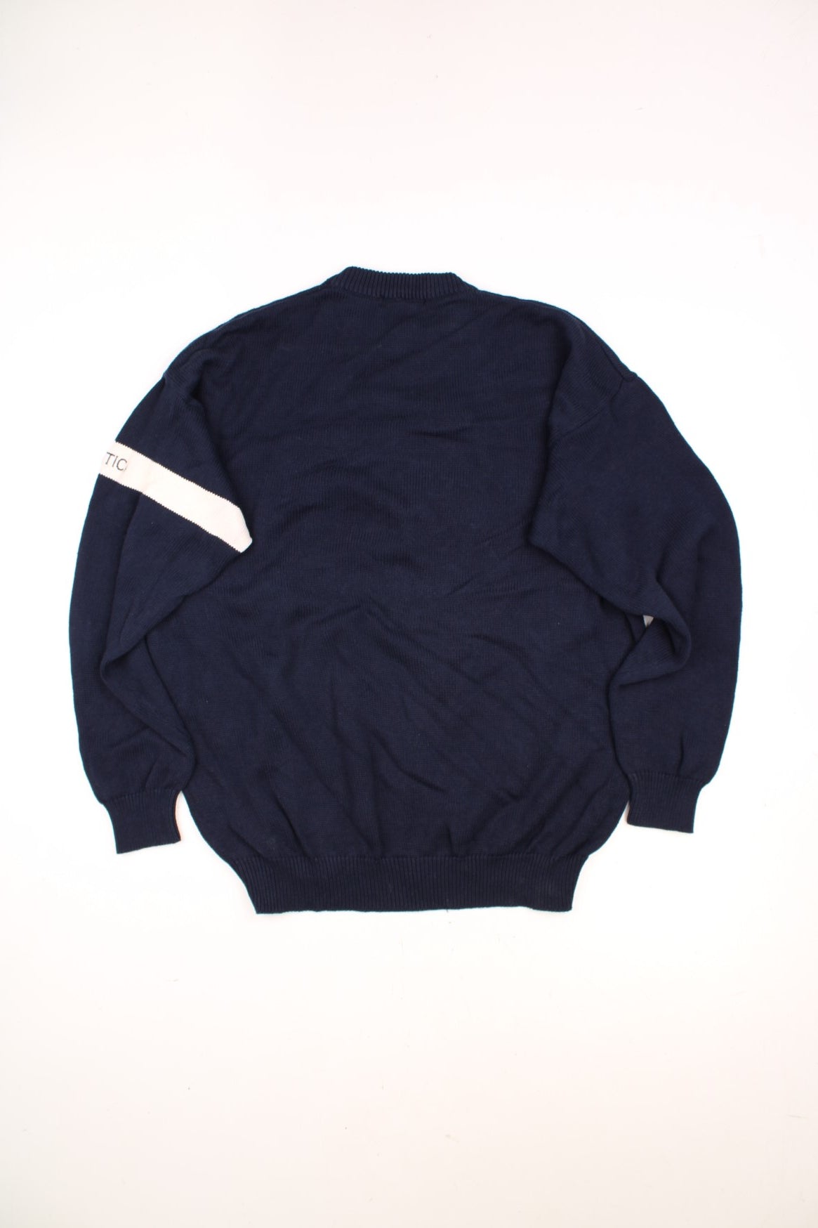 Nautica American Yachting Knitted Jumper in a navy blue and white colourway with the spell out logo and yatch graphic embroidered on the front. 