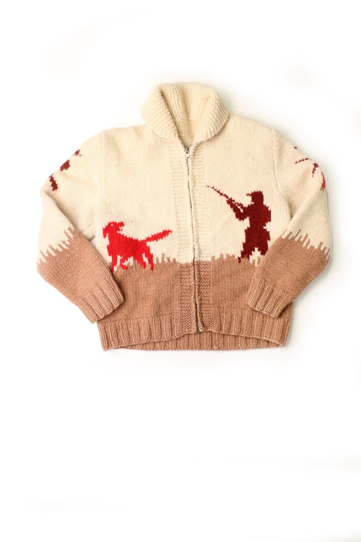 Vintage unbranded cream and brown Cowichan cardigan with zip closure, a rounded collar and red designs of dogs, geese and hunters.  