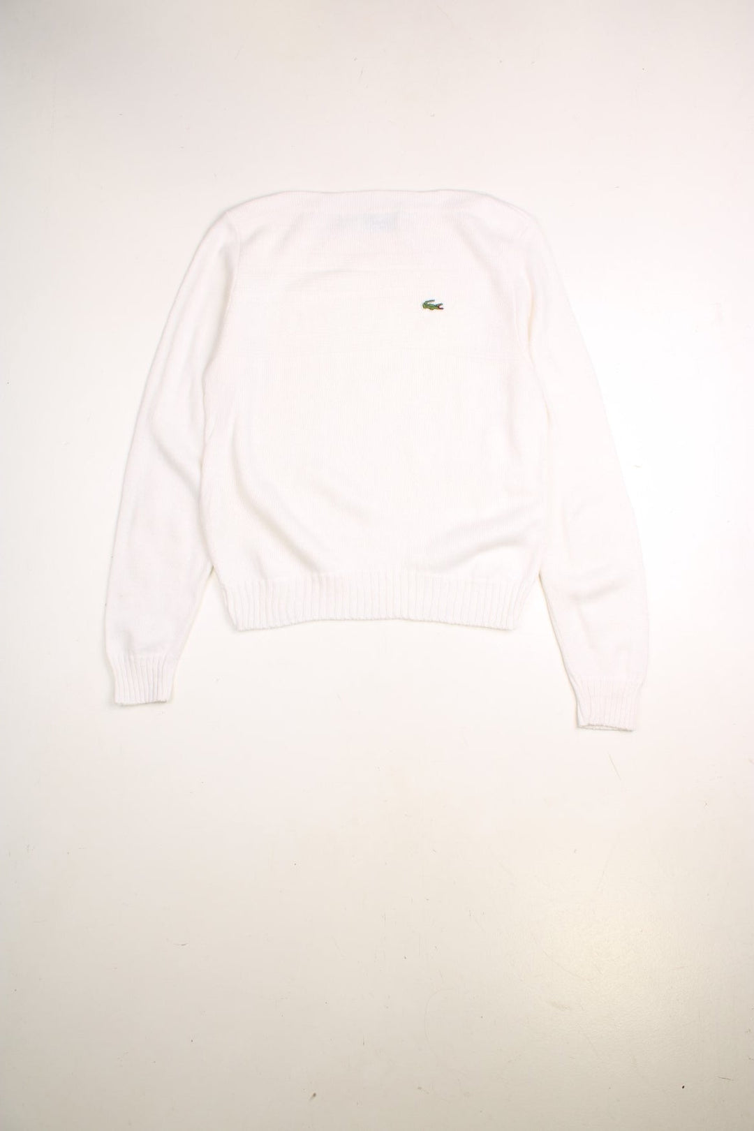 Lacoste jumper in a white colourway with a slash neck, ribbed knitted pattern across the chest and the Lacoste logo embroidered on the front.