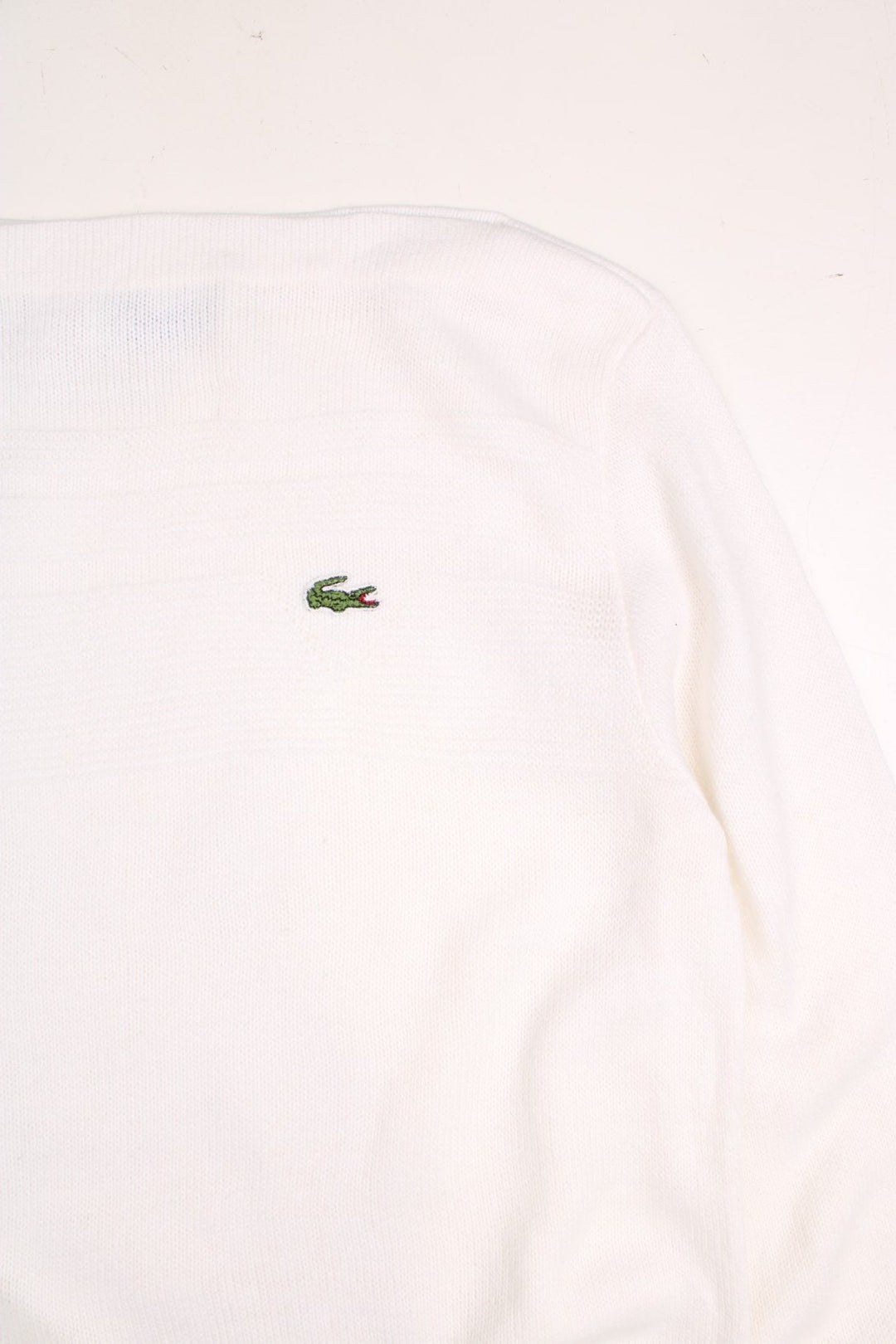 Lacoste jumper in a white colourway with a slash neck, ribbed knitted pattern across the chest and the Lacoste logo embroidered on the front.