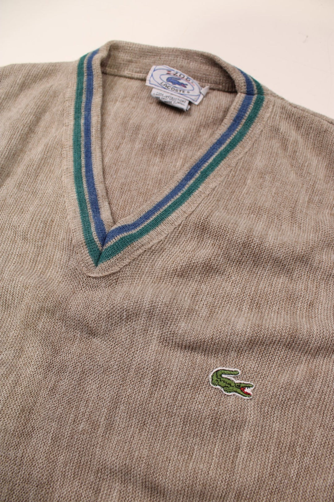 Lacoste lightwright v-neck jumper in tan with blue and green accent stripes, and a crocodile logo embroidered on the front.