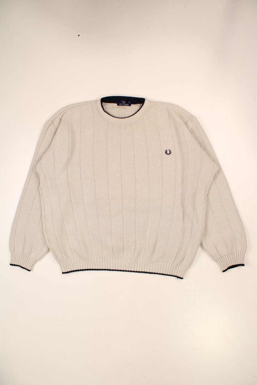 Fred Perry knit jumper in off-white with navy blue accents at the hem, collar, and cuffs, and an embroidered laurel logo on the chest.