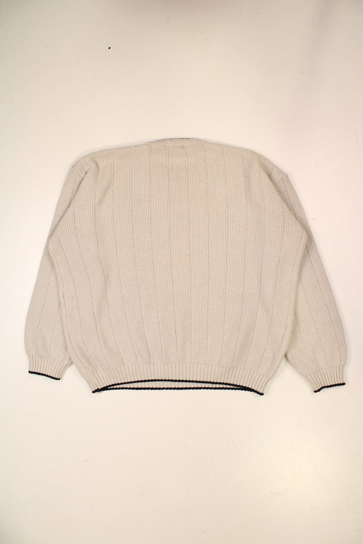 Fred Perry knit jumper in off-white with navy blue accents at the hem, collar, and cuffs, and an embroidered laurel logo on the chest.