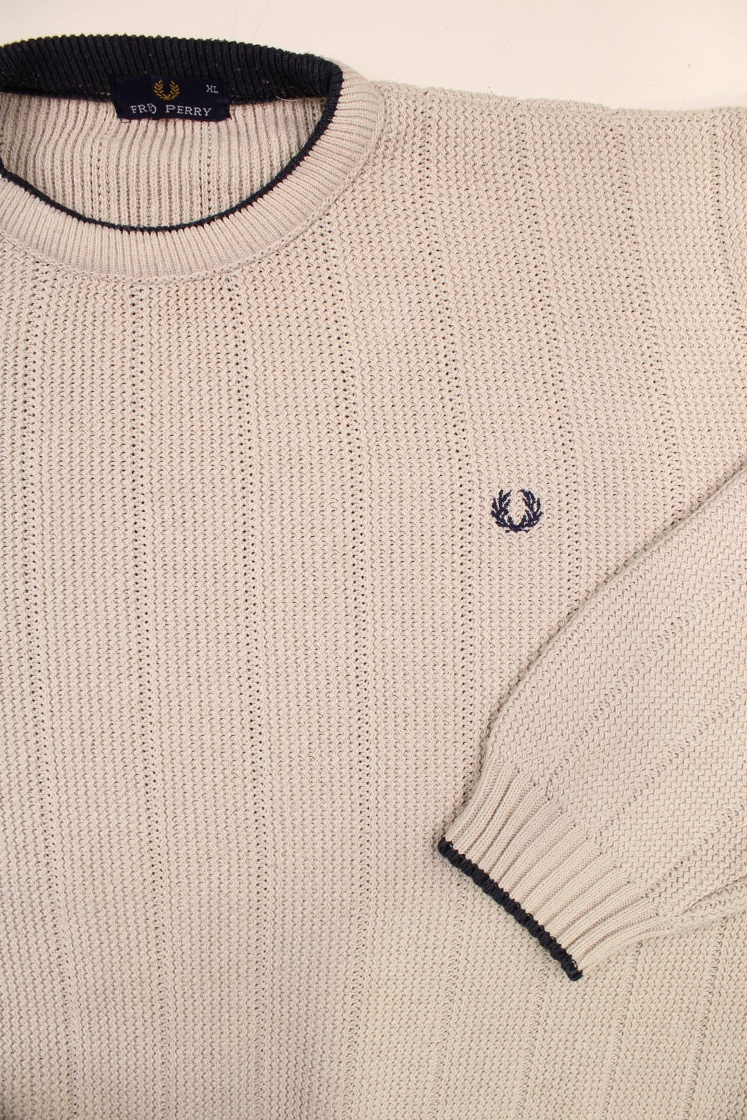 Fred Perry knit jumper in off-white with navy blue accents at the hem, collar, and cuffs, and an embroidered laurel logo on the chest.