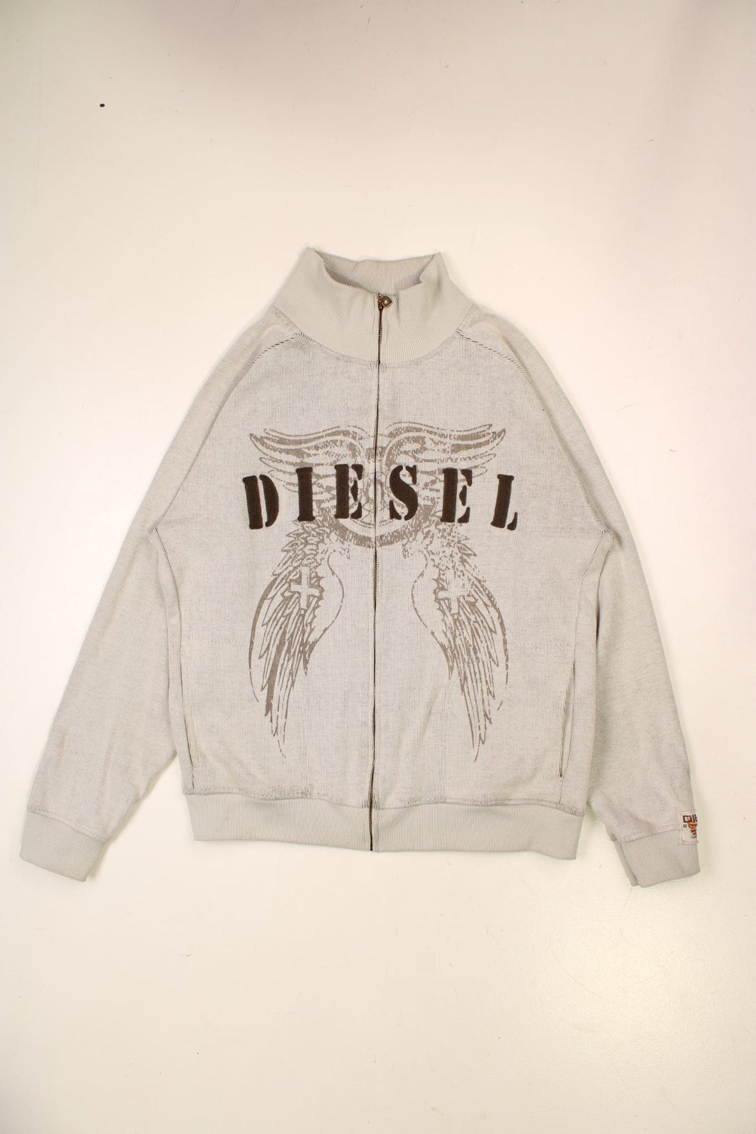 Diesel zip-through raglan sleeve cardigan in pale grey with embroidered spellouts front and back, wing designs, and a logo patch on one sleeve.