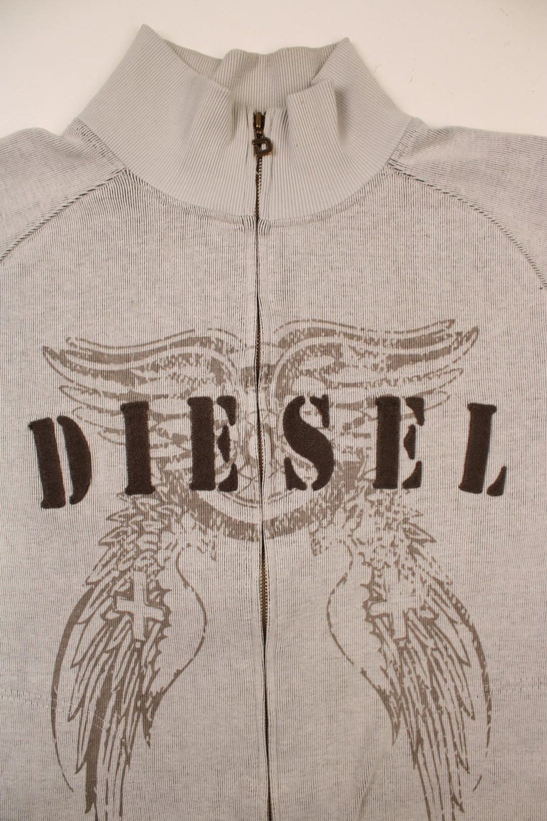 Diesel zip-through raglan sleeve cardigan in pale grey with embroidered spellouts front and back, wing designs, and a logo patch on one sleeve.