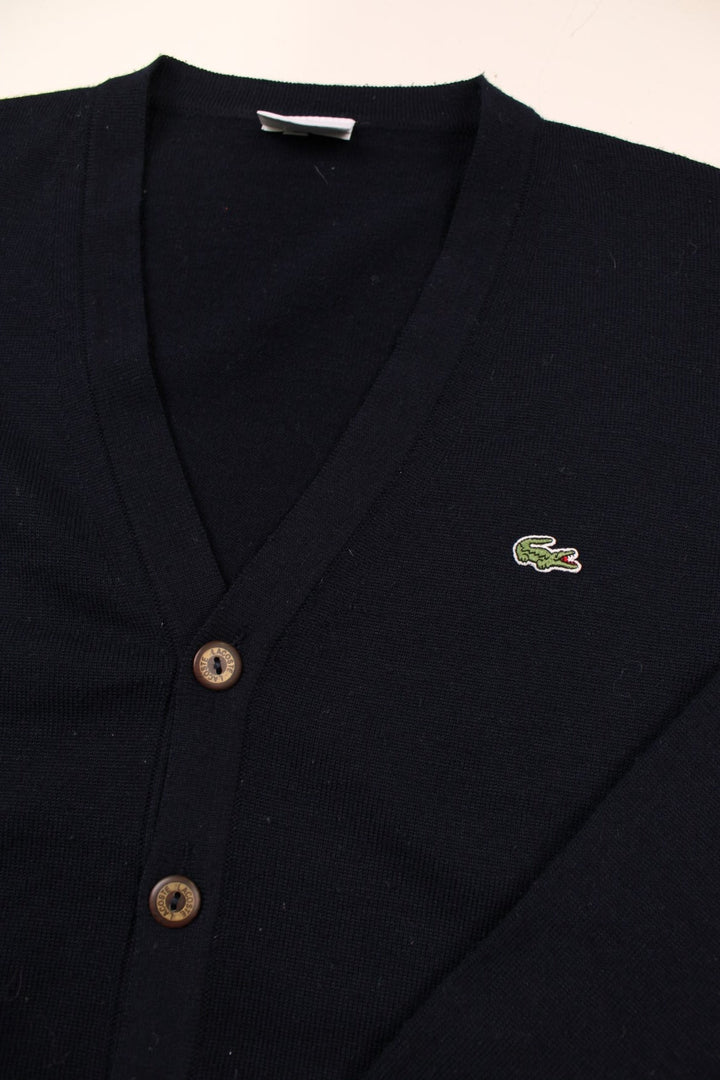 Lacoste lightweight cardigan in navy blue with brown buttons, and a crocodile logo embroidered on the front.