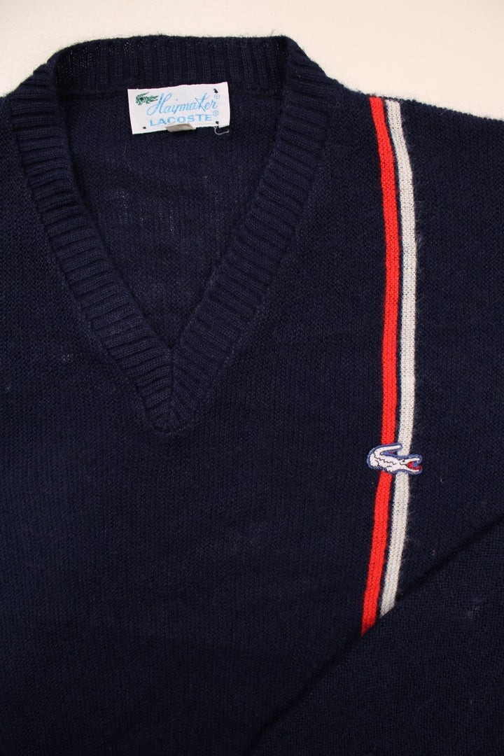 Lacoste lightweight v-neck jumper in navy blue with a red and white accent stripe, and a crocodile logo embroidered logo on the front.