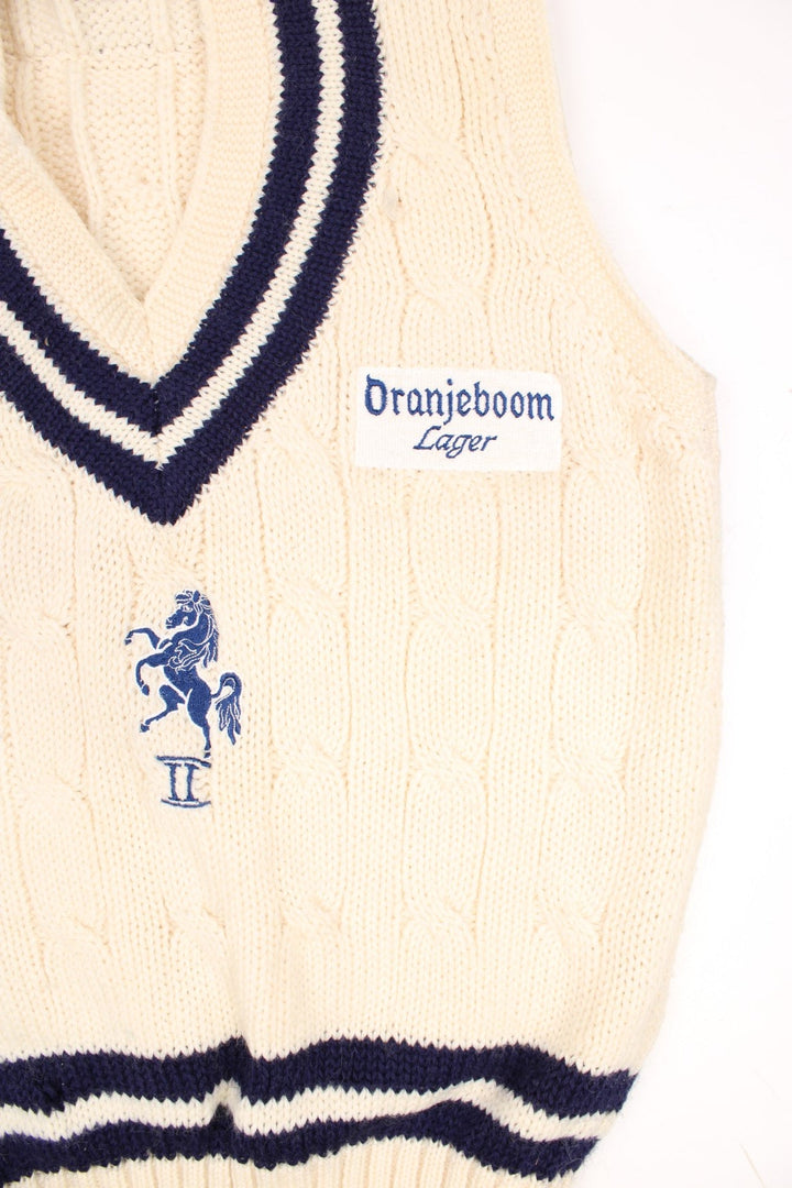 Vintage Allez by MCM sleeveless knitted cricket vest in white and blue. Features embroidered Oranjeboom Lager badge. 