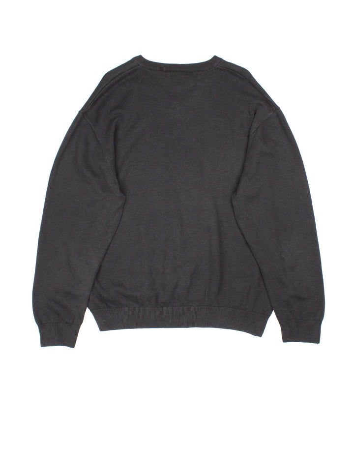 Lacoste Jumper in a black colourway with contrast white and grey stripe. V neck, with cuffed hems and embroided logo.