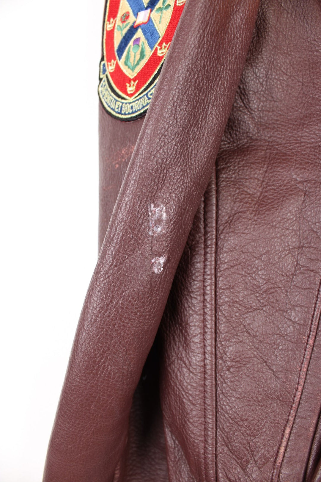 Vintage 80's Queen's University Canada Leather Varsity Jacket in a brown colourway, zip and button up, side pockets, and has the university logo and badges embroidered on throughout. 