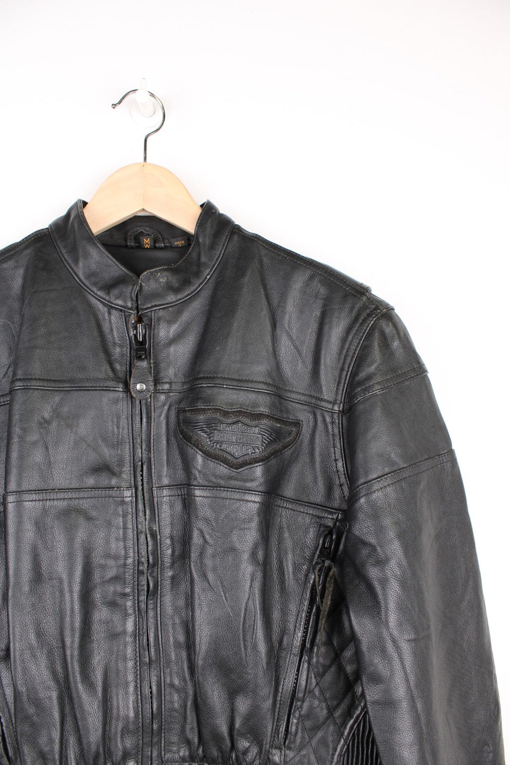 Harley Davidson Motorcycle Jacket in a black colourway, zip up with side pockets, has adjustable waistline buckles, air vent zip on the back, mesh lining, and the logo embroidered on the front and spell out on the back. 