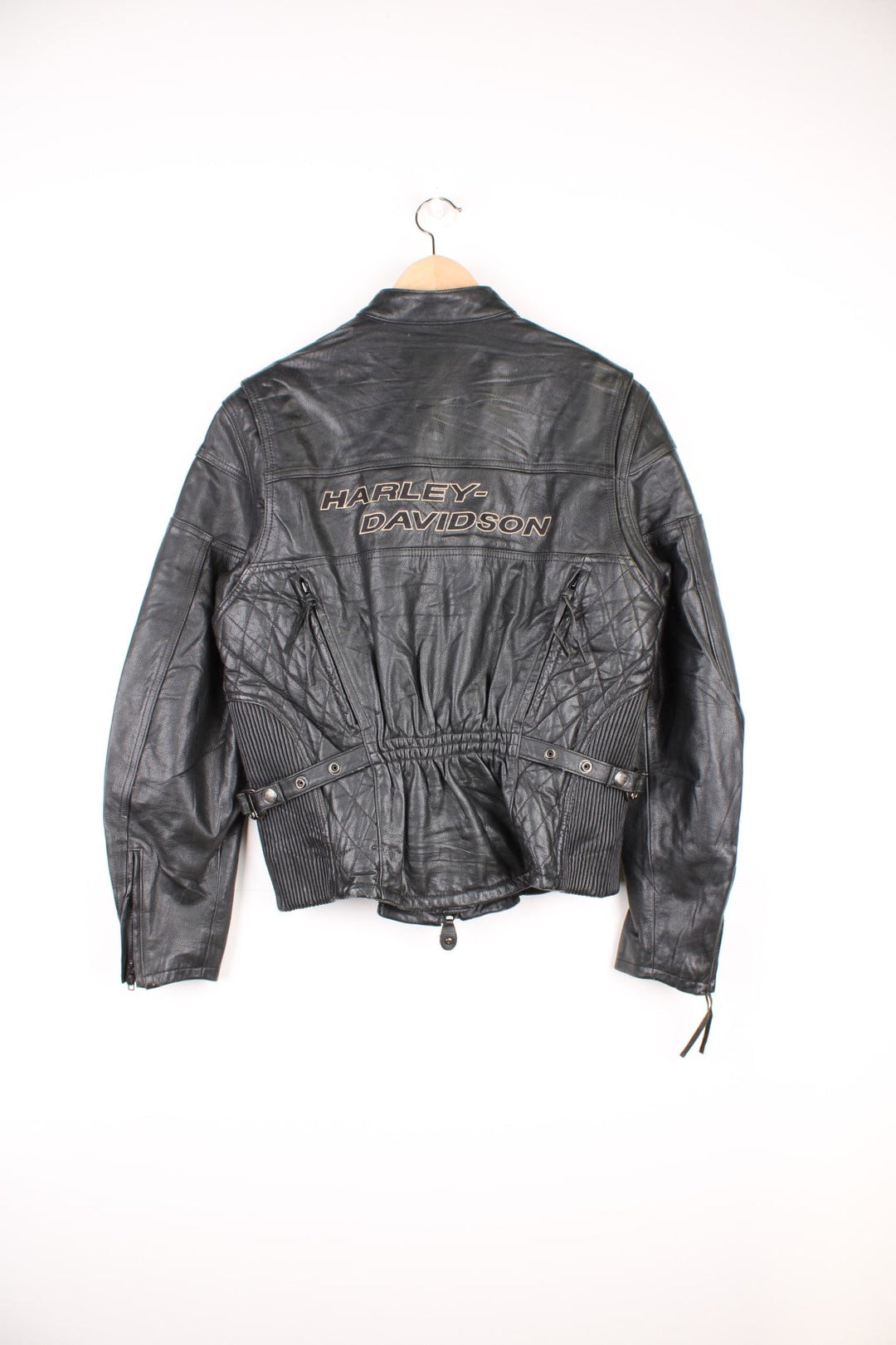 Harley Davidson Motorcycle Jacket in a black colourway, zip up with side pockets, has adjustable waistline buckles, air vent zip on the back, mesh lining, and the logo embroidered on the front and spell out on the back. 