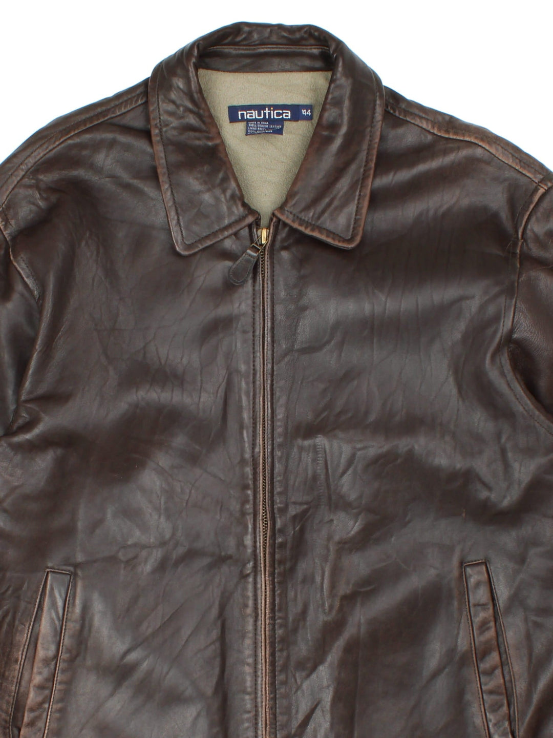 Vintage Nautica Leather Jacket in a brown colourway. Full zip up with double pocket on the front with thin fleece lining.