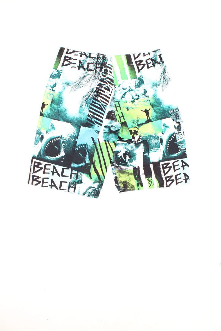 Y2K Billabong Beach Shorts in a surf patterned green, blue and white colourway, has an adjustable waist, and only has 1 cargo style pocket. 