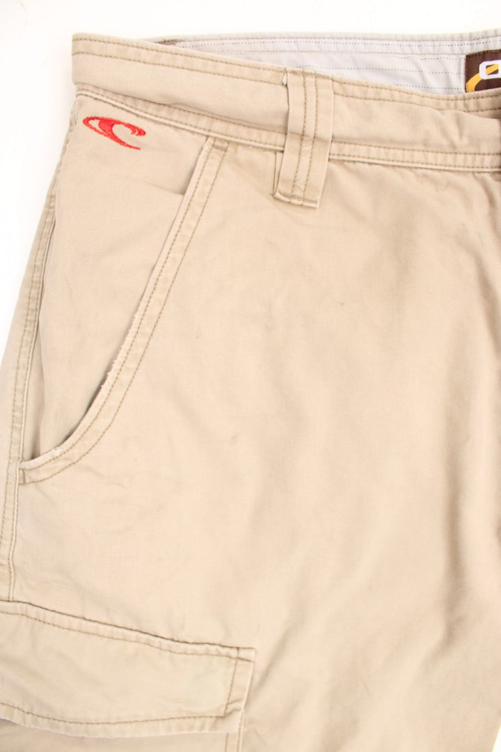 Vintage O'Neill Cargo Shorts in a tanned colourway, has multiple pockets, adjustable cuffs at the bottom, and has the logo graphic printed on the back by the left pocket. 