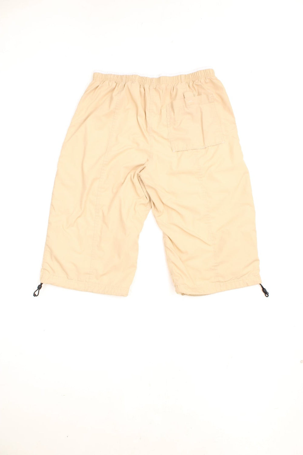 Y2K Nike Quarter Length Shorts in a tanned colourway, pin tucked with big pockets, has an adjustable waist, and the logo embroidered on the front.