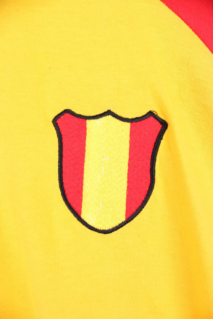 Umbro Spain Football T-Shirt in a yellow and red colourway with the logos printed on the front and on the back is the Spain spell out print.