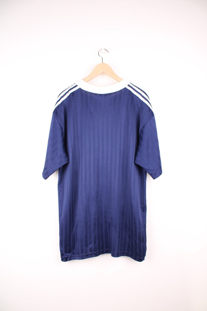 Adidas Training Top in a navy blue and white colourway with the iconic three stripes going down the shoulders and the spell out logo embroidered on the front. 