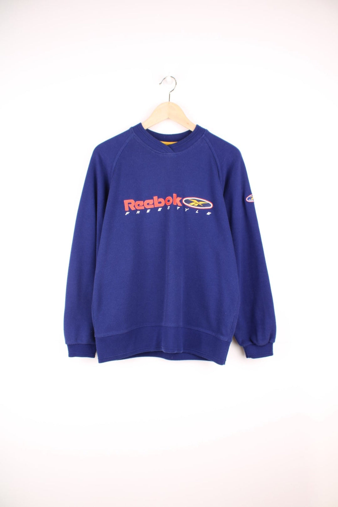 Reebok Freestyle Sweatshirt in a blue colourway with the spell out logo embroidered across the front and on the left sleeve.