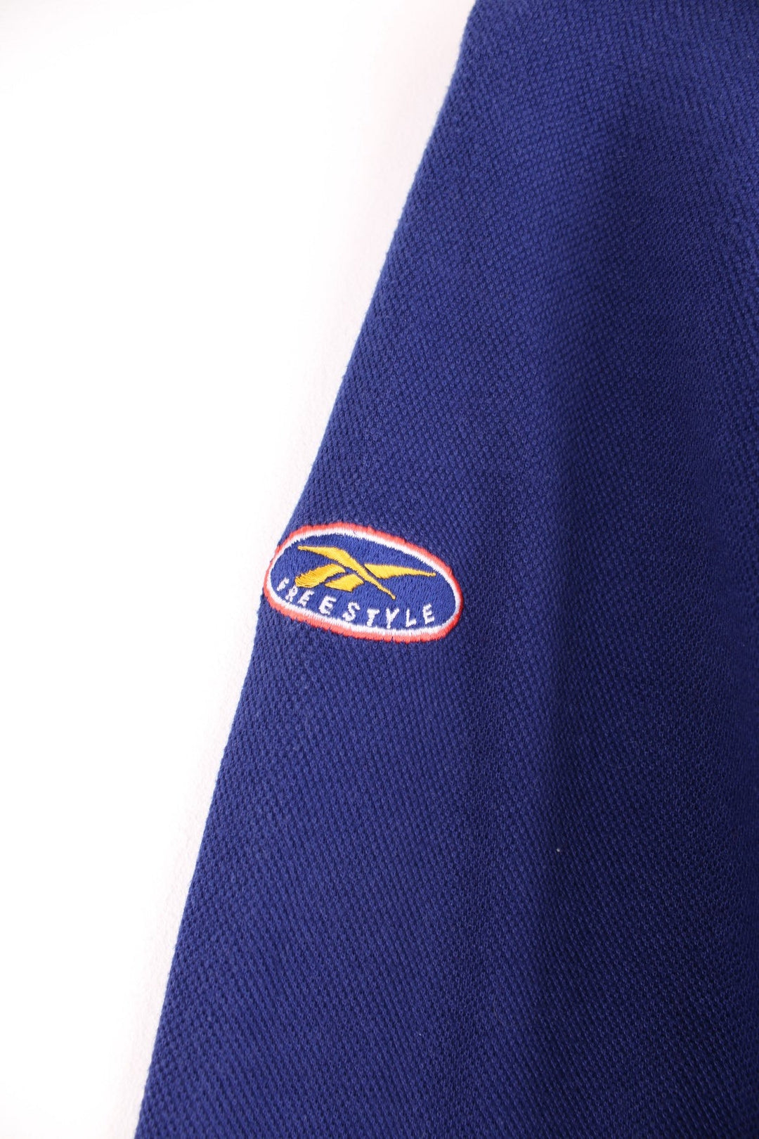 Reebok Freestyle Sweatshirt in a blue colourway with the spell out logo embroidered across the front and on the left sleeve.