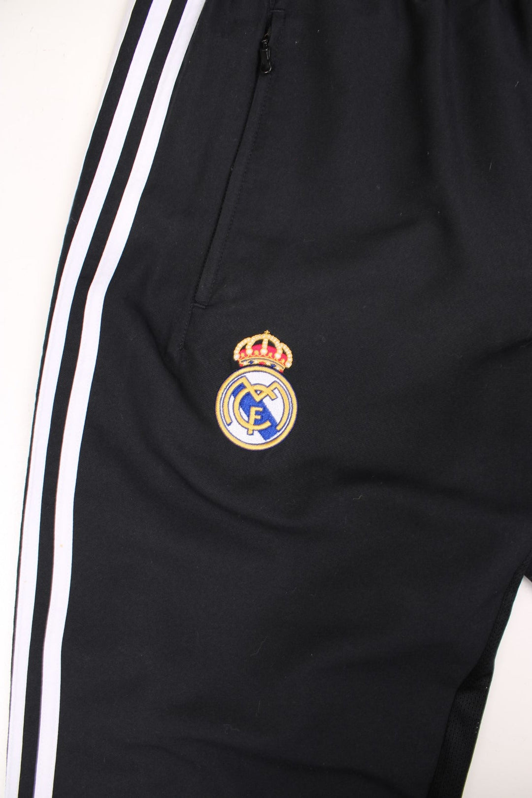 Real Madrid Adidas Tracksuit Bottoms in a black and white colourway, has an elasticated waist with drawstrings, pockets, and the logos embroidered on the front. 