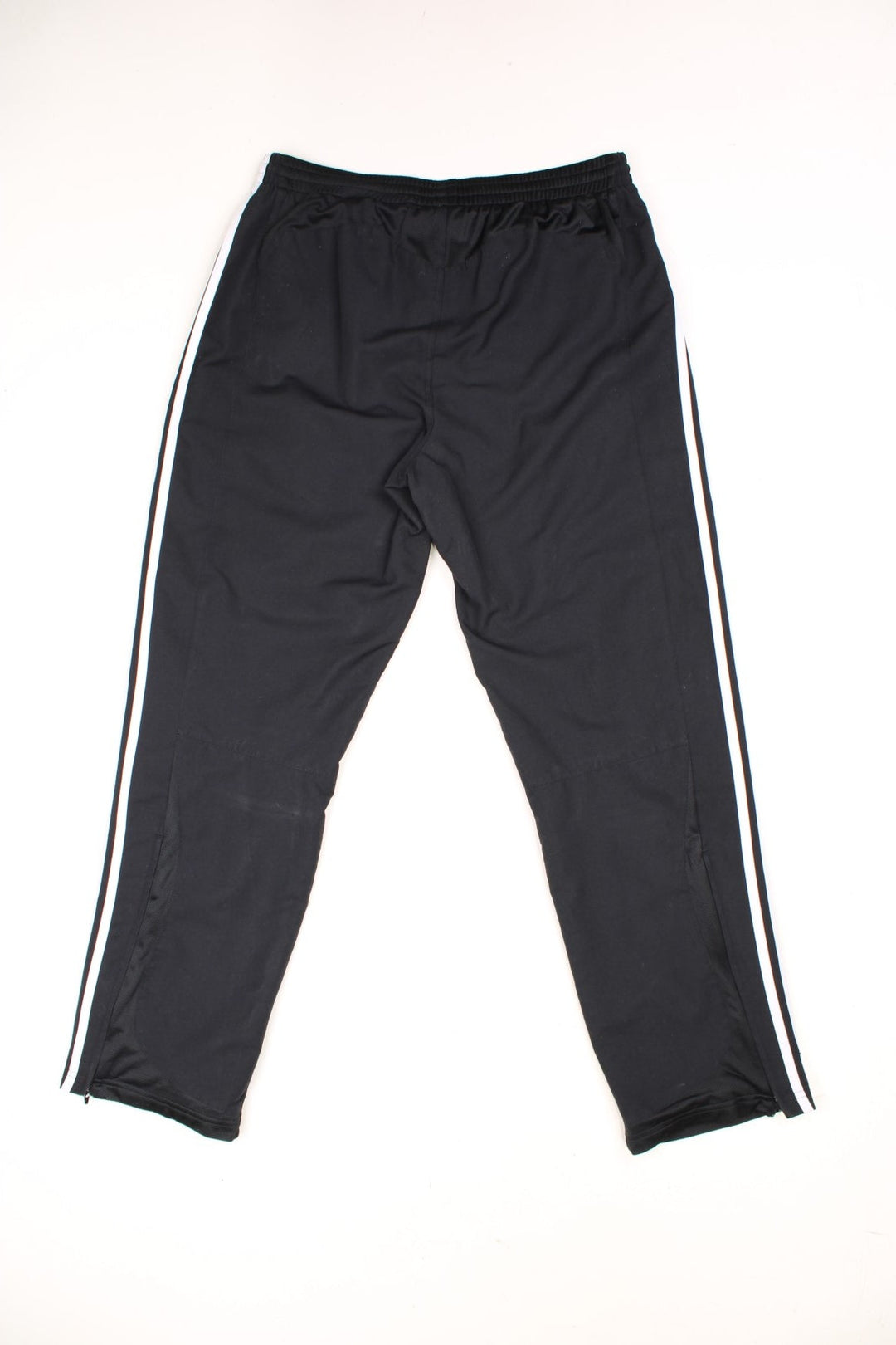 Real Madrid Adidas Tracksuit Bottoms in a black and white colourway, has an elasticated waist with drawstrings, pockets, and the logos embroidered on the front. 