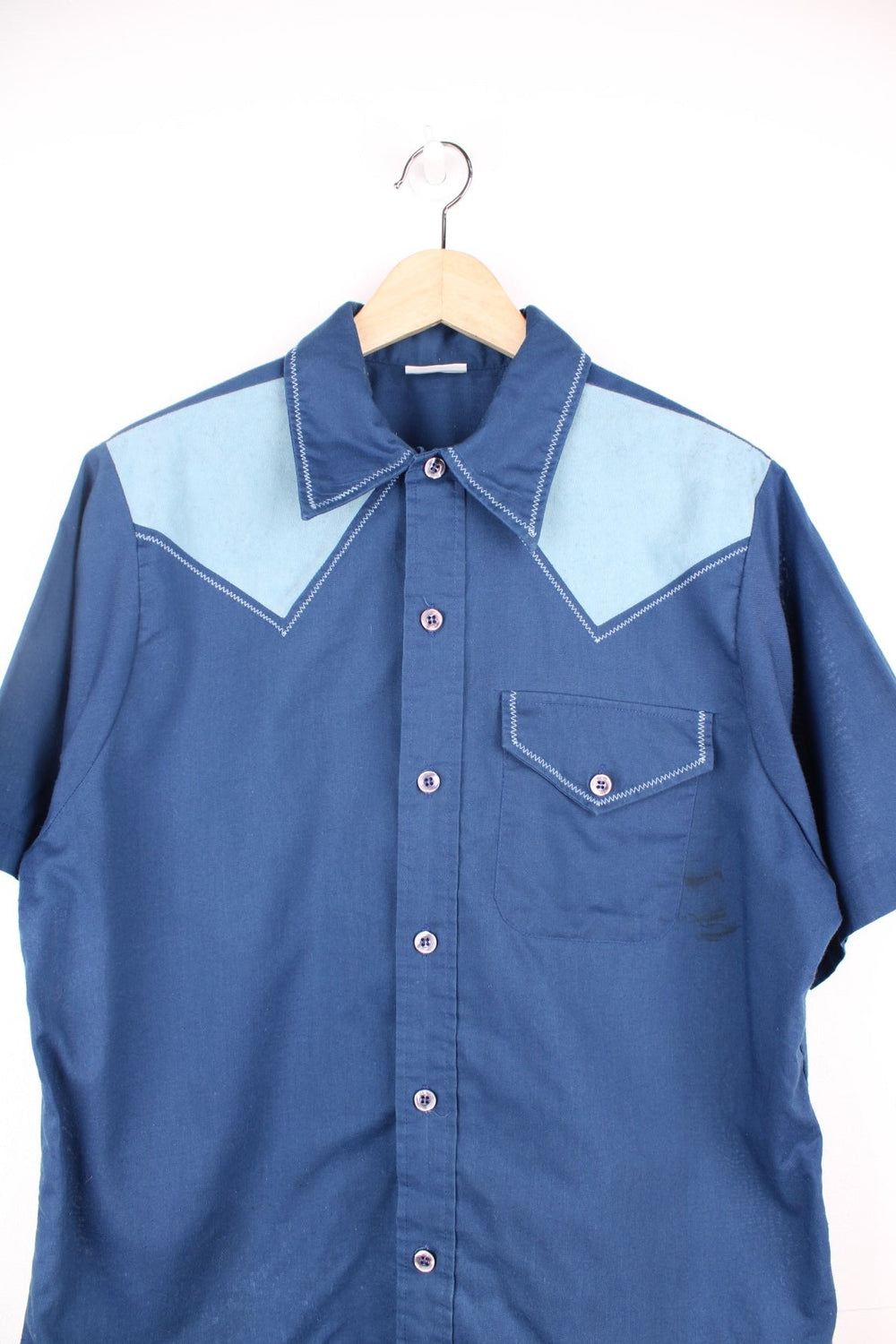 Vintage 70's Bowling Shirt in a blue colourway with western style cross stitching, button up with a dagger collar, has a chest pocket and also has 'Bowlerama, Idaho' graphic printed on the back.