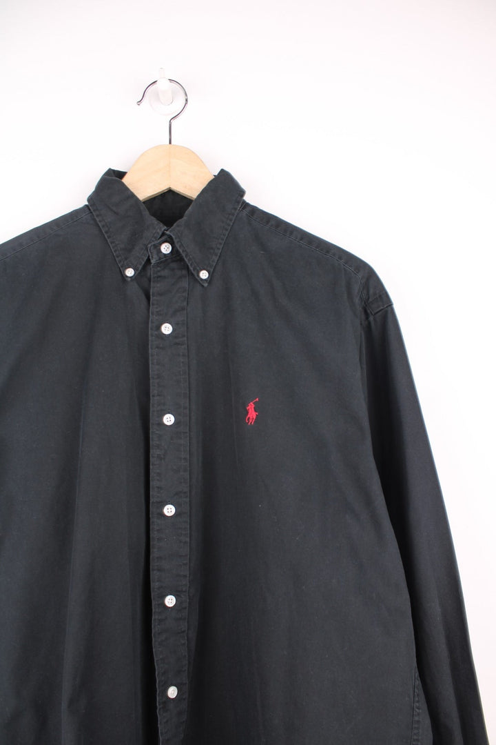 Ralph Lauren Shirt in a plain black colourway, button up and has the logo embroidered in red on the chest.