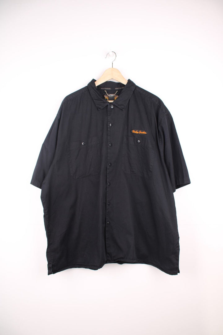 Harley Davidson Work Shirt in a black colourway, short sleeve button up shirt, double chest pockets, and has the logo embroidered on the front, back and right sleeve. 