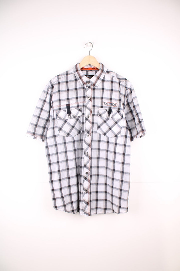 Harley Davidson Checkered Shirt in a white, black and grey colourway, short sleeve button up shirt, has double chest pockets, and the logo printed on the front and back. 