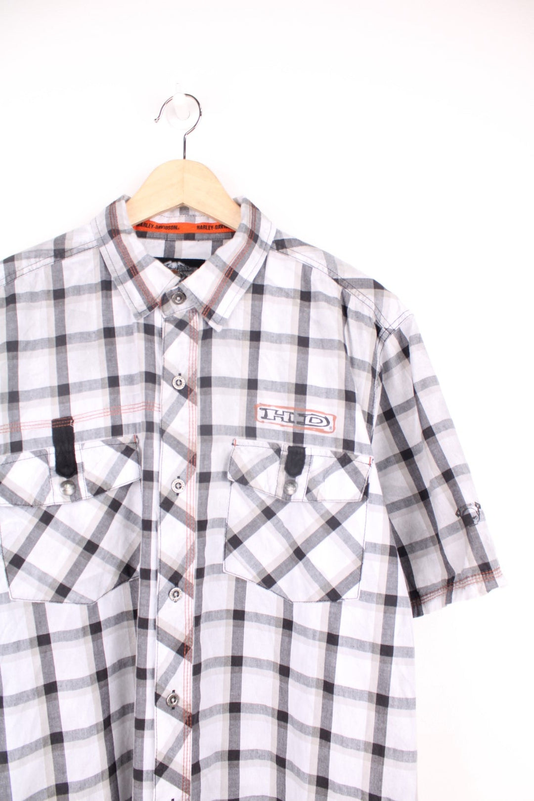 Harley Davidson Checkered Shirt in a white, black and grey colourway, short sleeve button up shirt, has double chest pockets, and the logo printed on the front and back. 