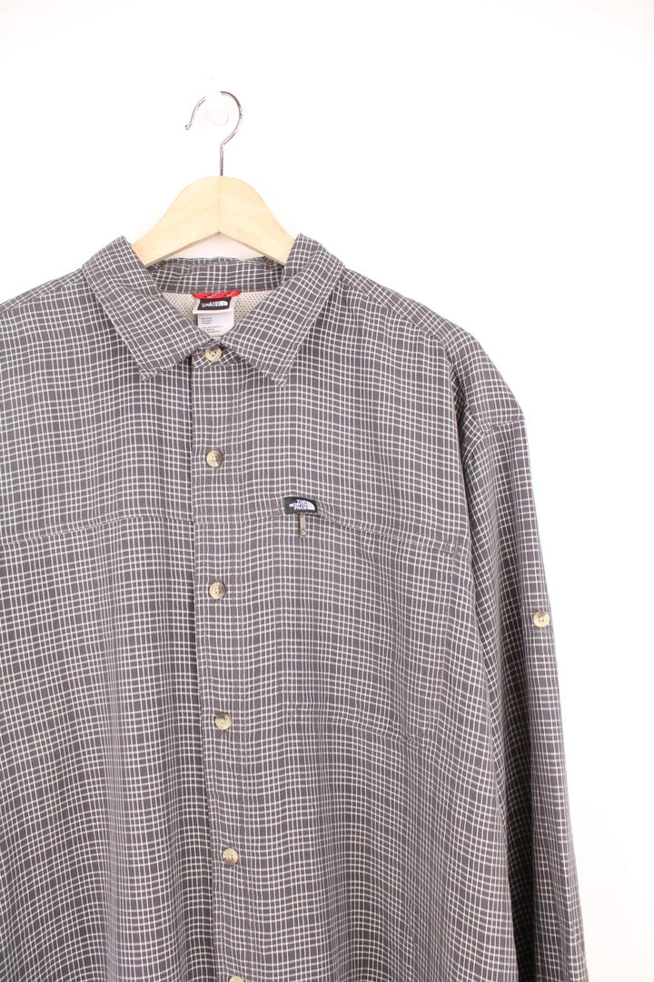 The North Face Shirt in a grey and white plaid colourway, button up, and has a chest pocket with the logo embroidered on. 