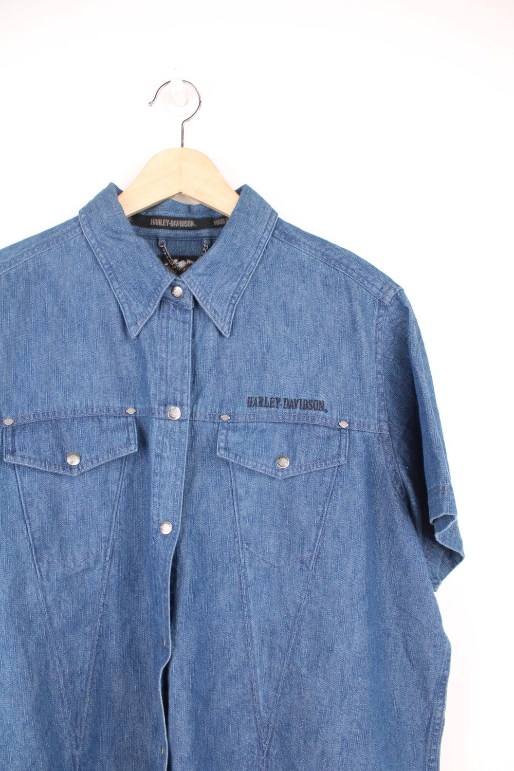 Harley Davidson Denim Shirt in a blue colourway, short sleeve button up shirt, has double chest pockets and the logo embroidered on the front and back.