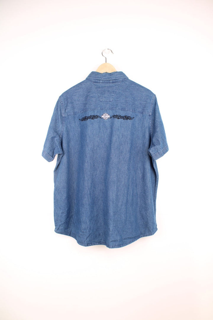 Harley Davidson Denim Shirt in a blue colourway, short sleeve button up shirt, has double chest pockets and the logo embroidered on the front and back.