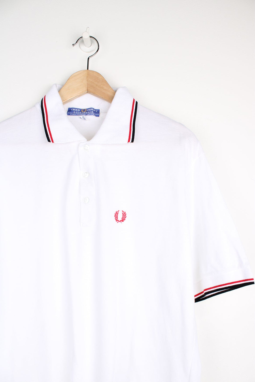 White and red Fred Perry Polo Shirt with embroidered logo on the chest.