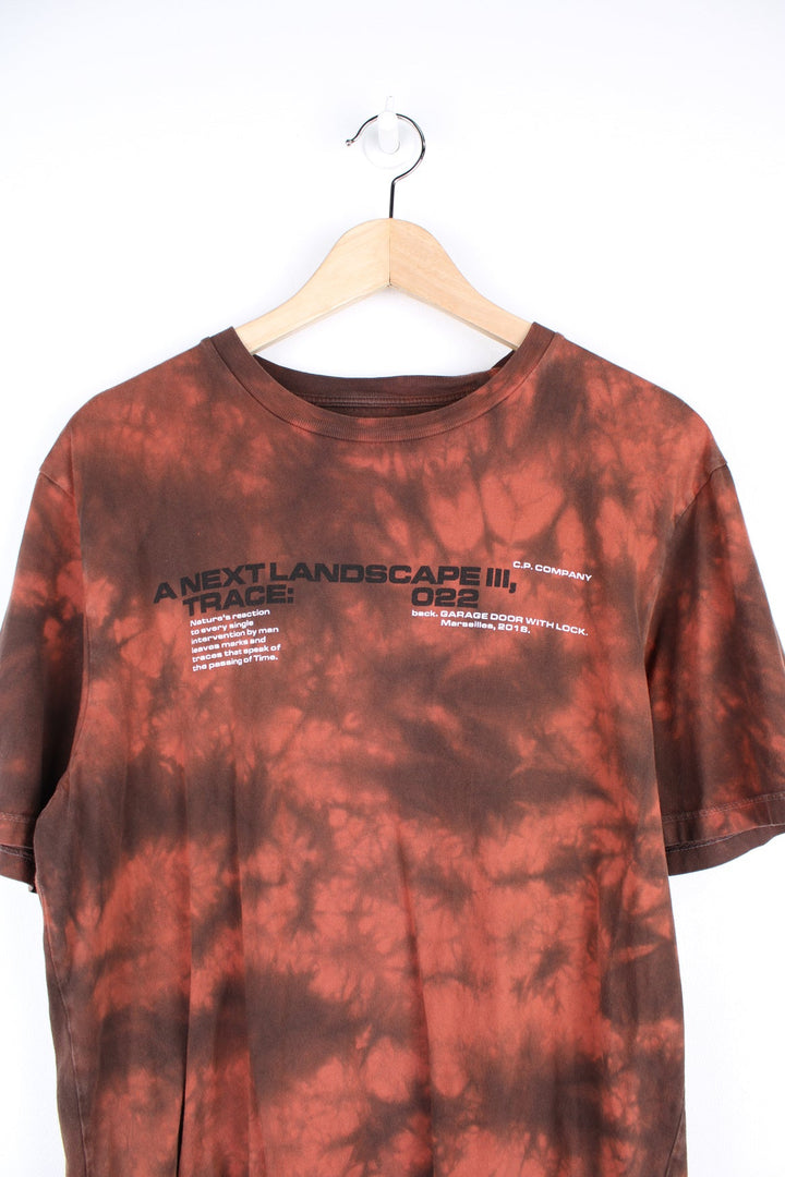 CP Company Next Landscape T-Shirt in red and black tie dye. Features graphic print on the front and back.