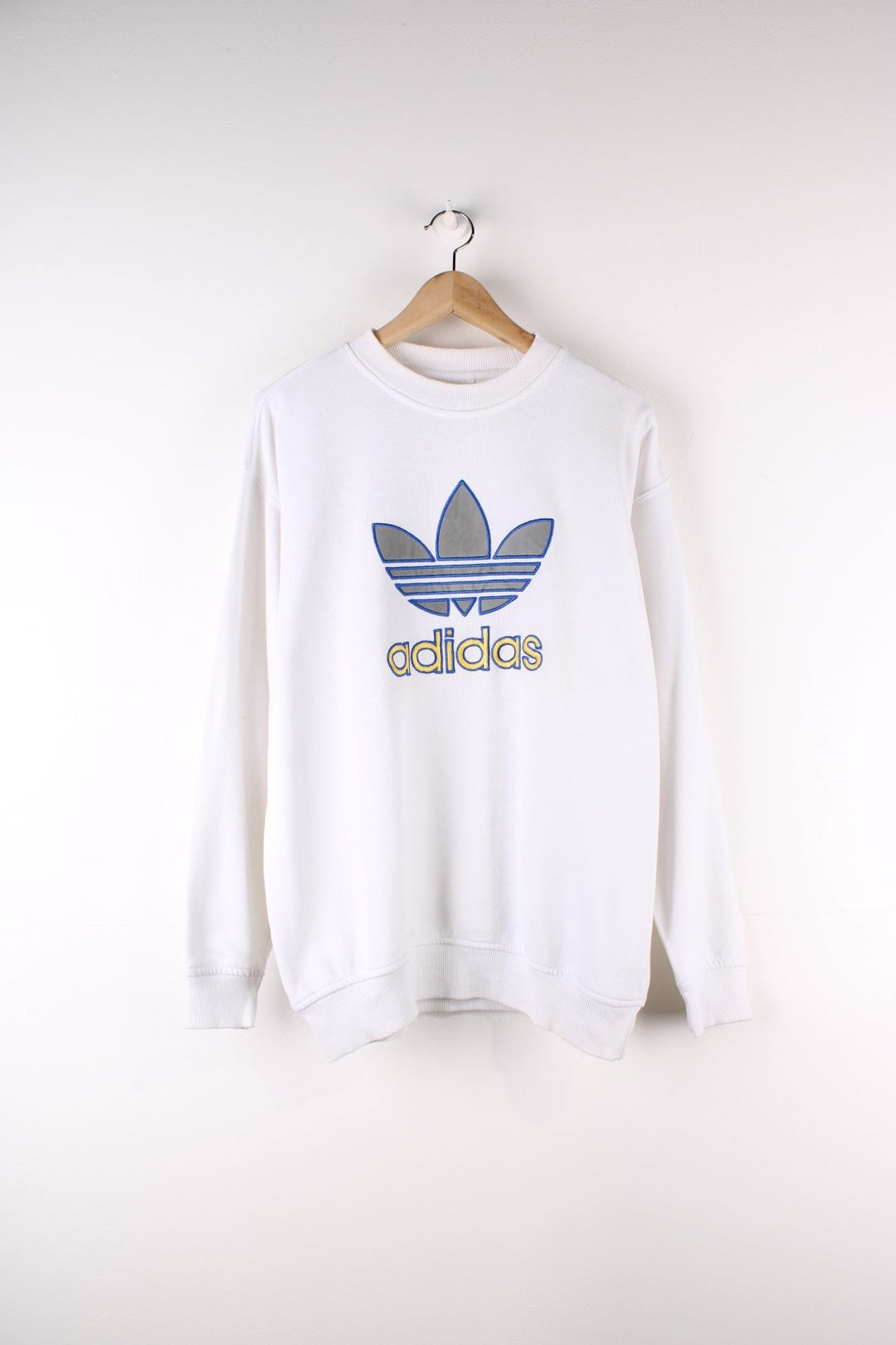 Vintage 90's Adidas Sweatshirt in a white colourway with the logo and spell out embroidered on the front.