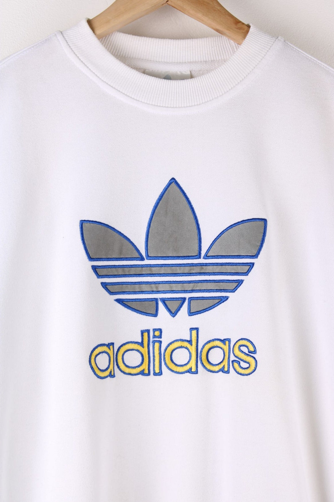 Vintage 90's Adidas Sweatshirt in a white colourway with the logo and spell out embroidered on the front.