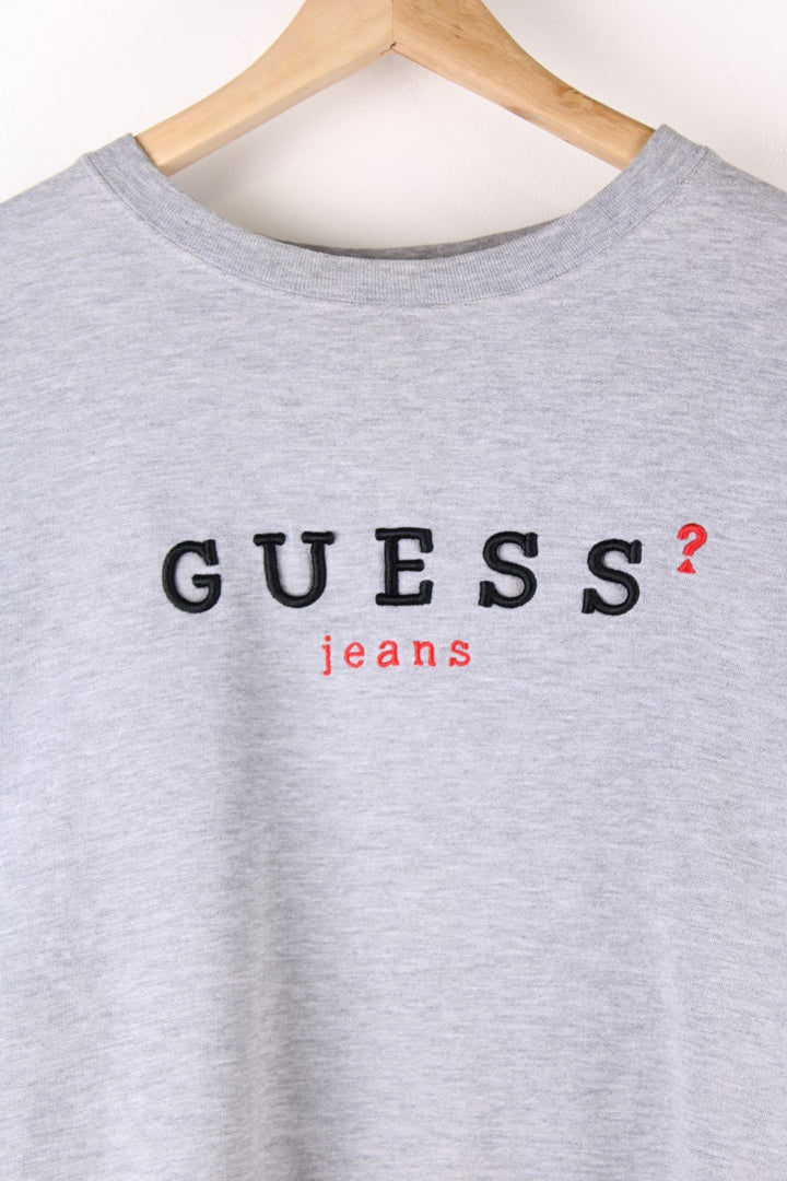 Vintage 90's Guess Sweatshirt in a grey colourway with the spell out embroidered on the front.