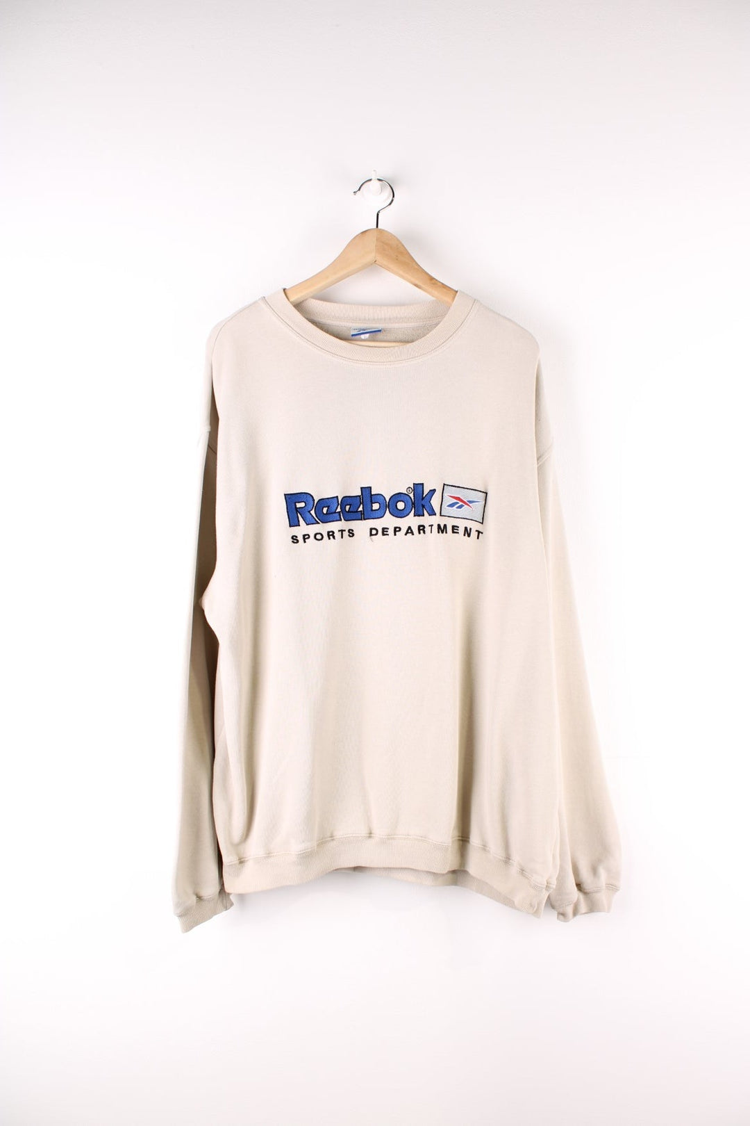 Vintage Reebok Sports Department Sweatshirt in a tan colourway with the spell out logo embroidered on the front.