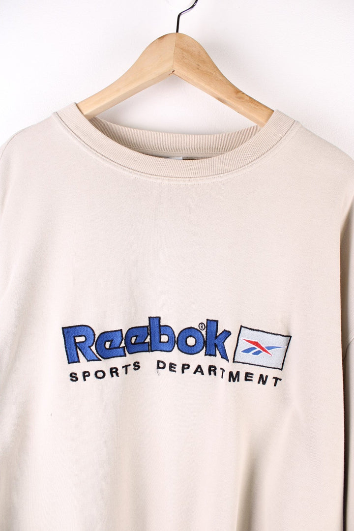 Vintage Reebok Sports Department Sweatshirt in a tan colourway with the spell out logo embroidered on the front.