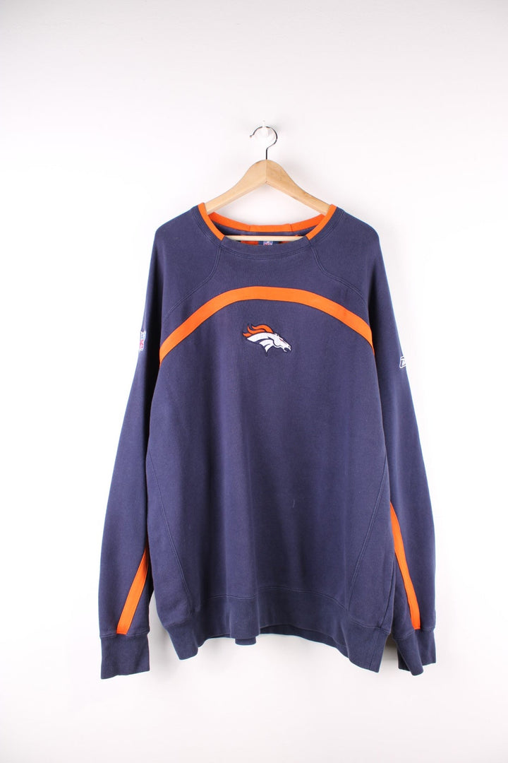 Vintage Denver Broncos NFL Reebok Sweatshirt in a blue and orange colourway with the logo embroidered on the front, and the Reebok and NFL logos on the sleeves.