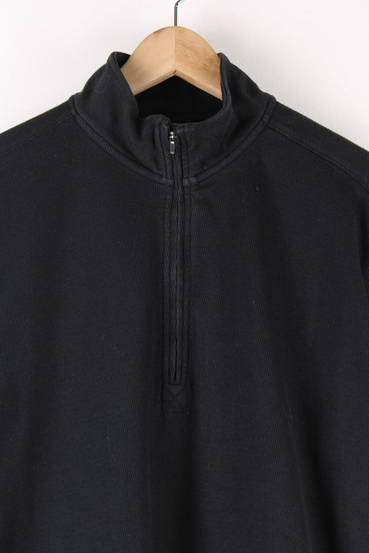 Carhartt Quarter Zip Sweatshirt in a black colourway with the logo embroidered on the front pouch pocket.