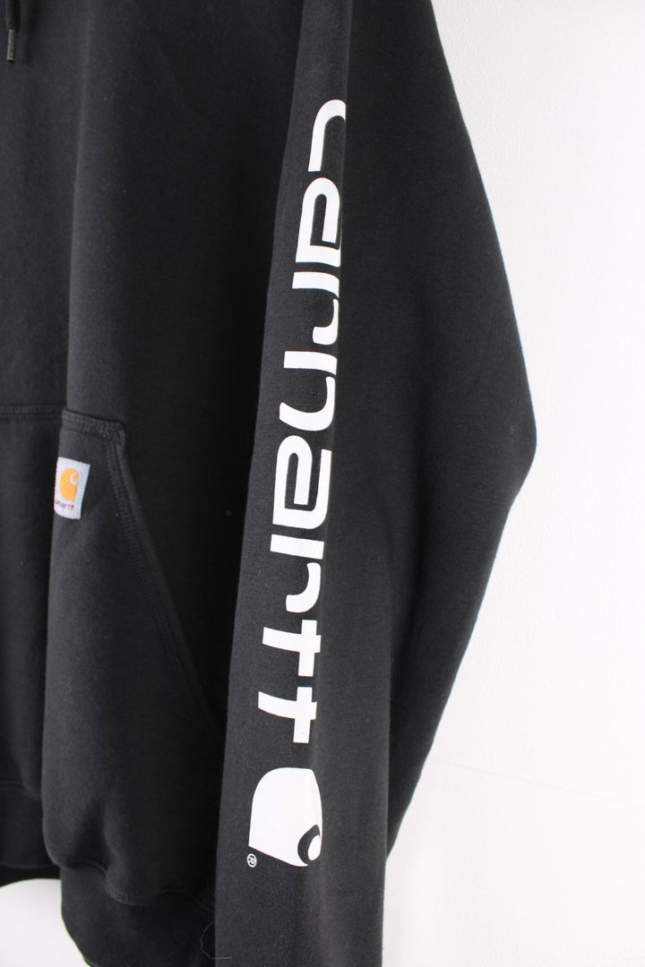 Carhartt Hoodie in a black colourway with the logo embroidered on the front pocket and spell out printed down the left sleeve.