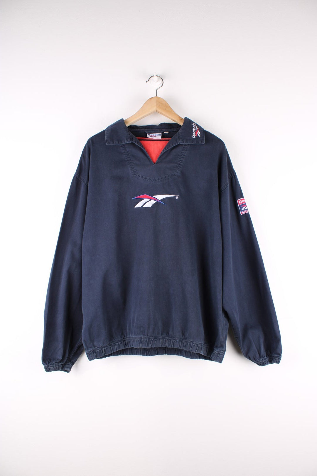 Vintage Reebok Training Top in a navy blue colourway with the logo embroidered on the front, back and on the collar.