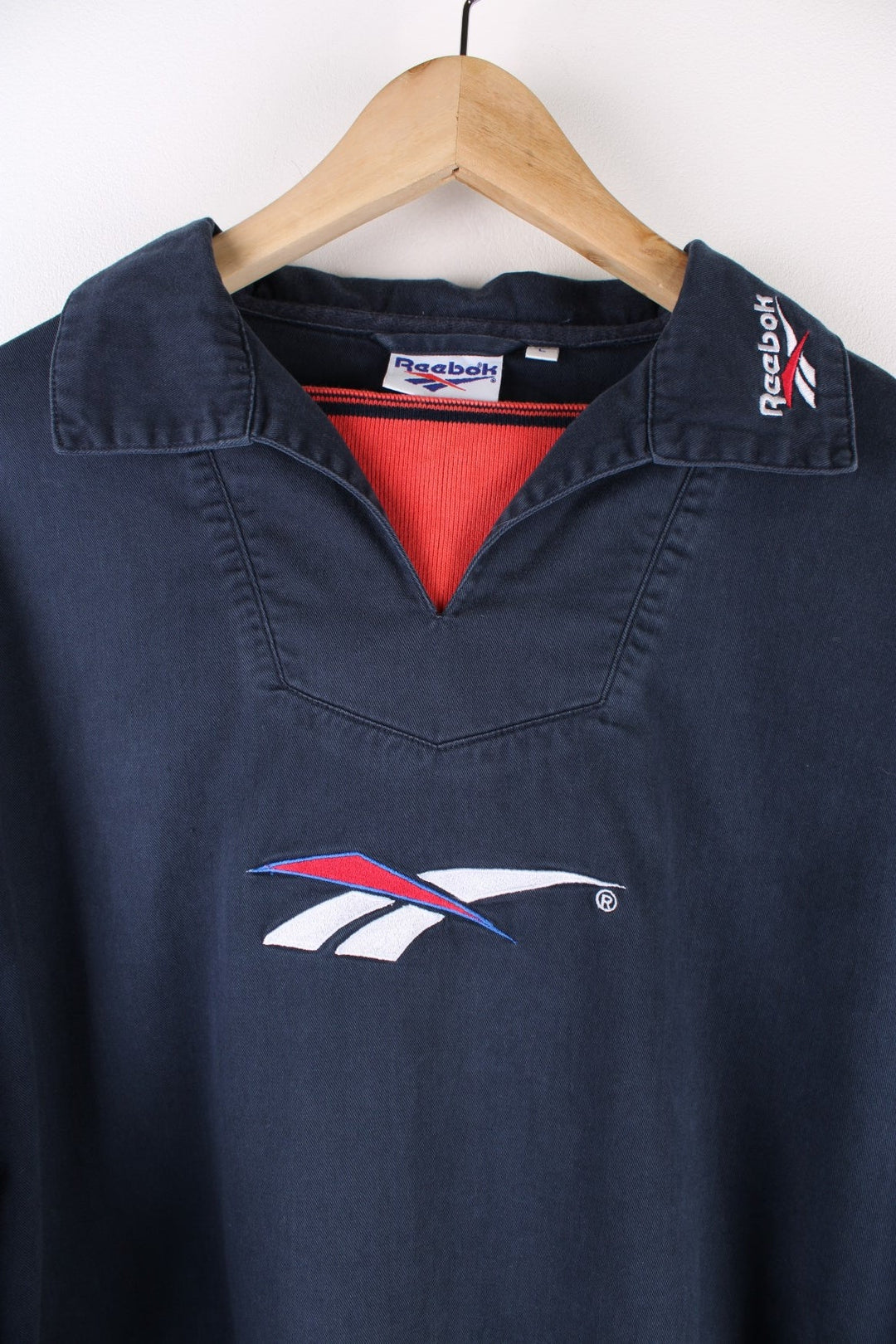 Vintage Reebok Training Top in a navy blue colourway with the logo embroidered on the front, back and on the collar.