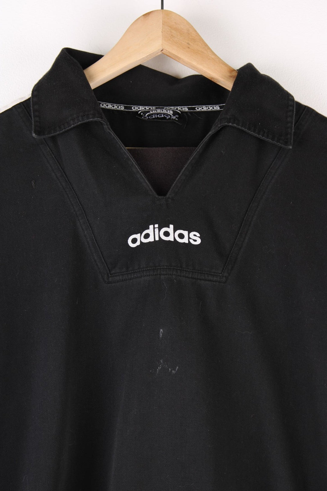 Vintage 90's Adidas Training Top in a black and white colourway, has the iconic three stripes going down the sleeves, and the logo is printed on front and back.